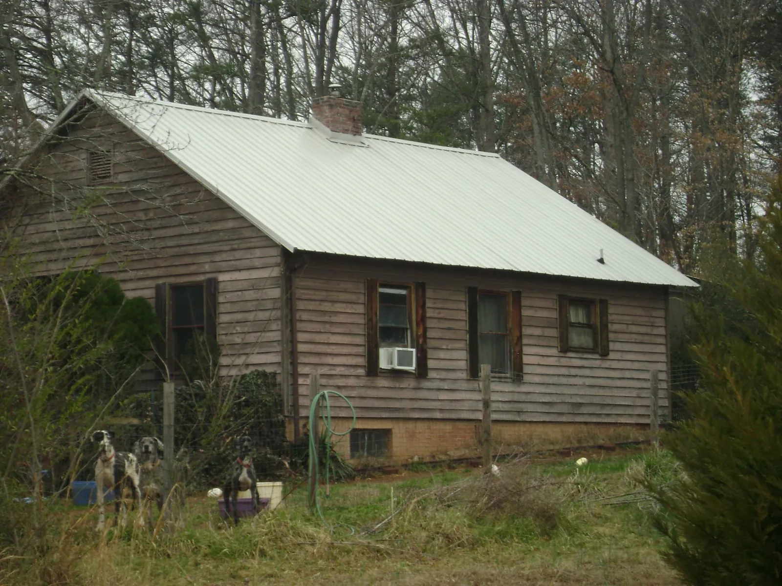 White metal roof on an old wood sided farmhouse, from a Asphalt Shingle Roof Repair job in Stoughton